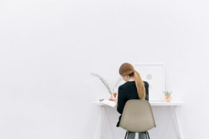 how to create content regularly woman at desk writing content